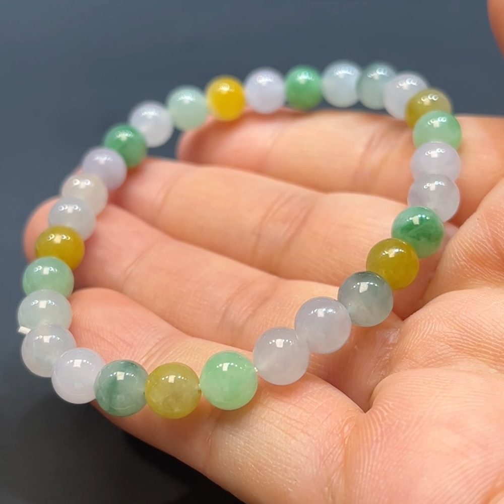 這款天然A級翡翠多寶手串（編號#260），精選多種色澤溫潤的翡翠珠，如陽綠、油青、紫羅蘭等自然多彩，珠粒圓潤飽滿，象徵五福臨門、福祿壽喜財齊聚一身。整體設計繽紛雅緻，寓意吉祥如意、福氣滿盈，是融合東方文化精髓與時尚品味的隨身幸運飾品。